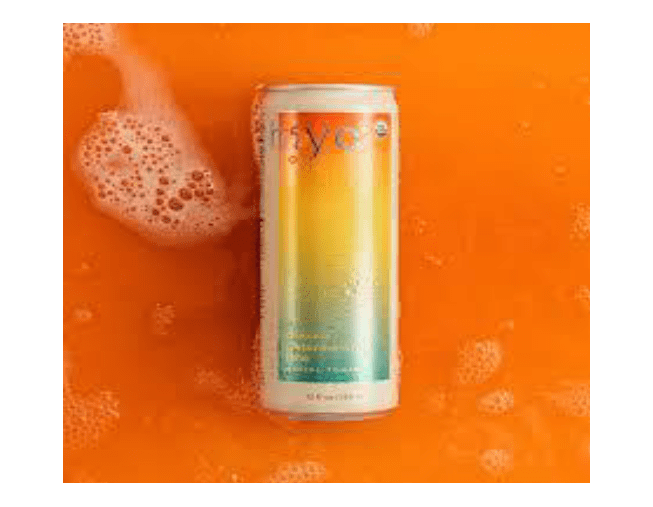 Can-shaped drink on a bright orange surface with bubbles.